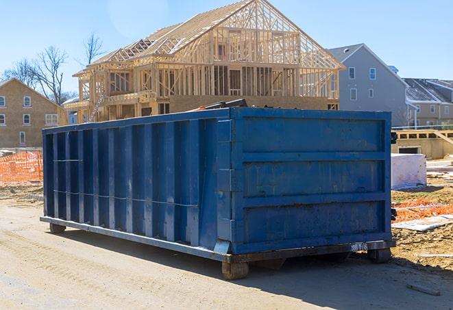 rows of residential dumpsters lined up on a commercial property